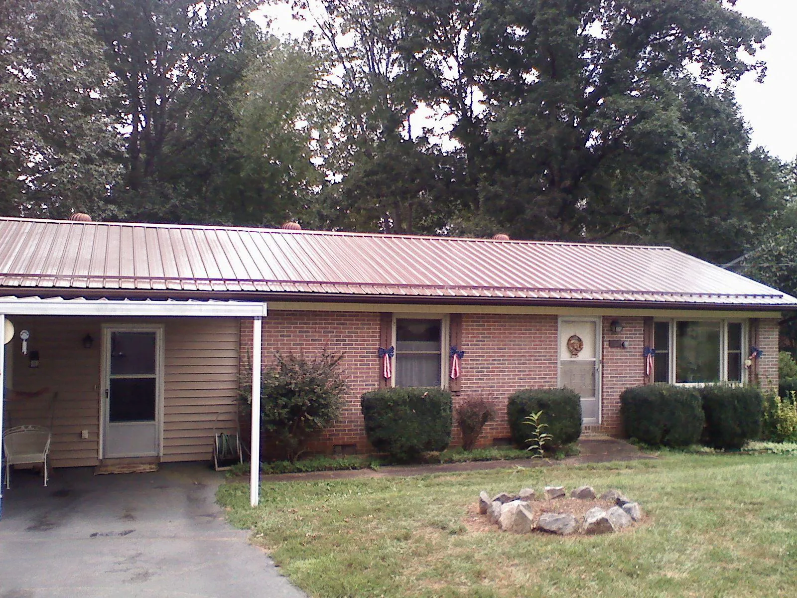 Bronze metal roof and carport on a brick ranch home — Roof Repair work by our crew in Hornbrook